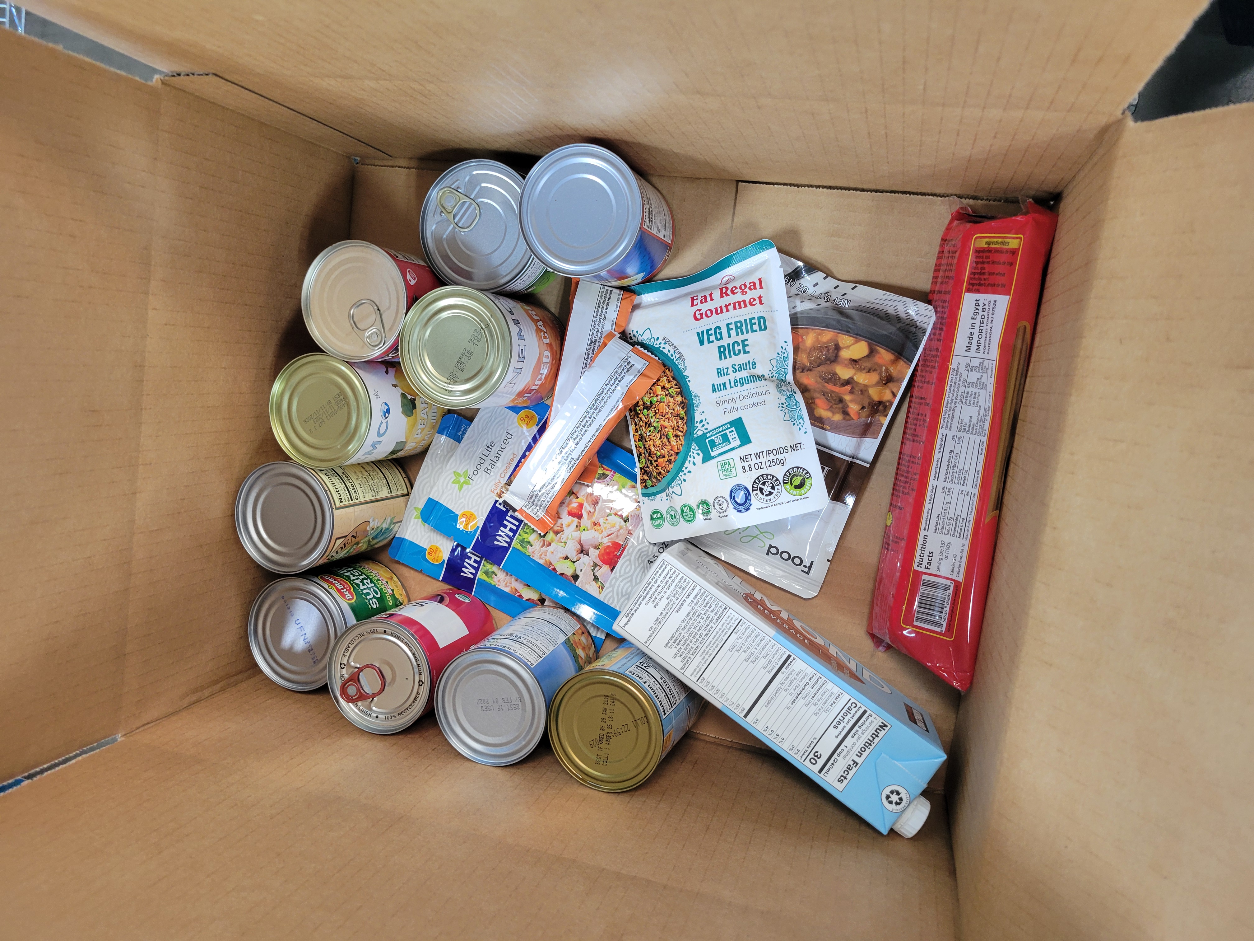 Cardboard box full of dry goods.